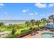 Breathtaking beach view from the condo showing palm trees, lush vegetation, and people enjoying the ocean at 2401 S Ocean Blvd. S # 267, Myrtle Beach, SC 29577