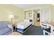 Comfortable bedroom featuring a twin bed, side table, and a doorway to another room at 2401 S Ocean Blvd. S # 267, Myrtle Beach, SC 29577