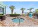 Inviting hot tub area featuring brick pavers, ocean views, and tropical landscaping for relaxation at 2401 S Ocean Blvd. S # 267, Myrtle Beach, SC 29577