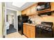 Functional kitchen with granite counters, wood cabinets, and appliances including a stove and microwave at 2401 S Ocean Blvd. S # 267, Myrtle Beach, SC 29577
