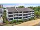 Aerial shot of a condo complex near the beach, showcasing its screened balconies at 250 Maison Dr. # J-11, Myrtle Beach, SC 29572