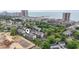 Overhead view of a condo community with a pool near a construction site by the ocean at 250 Maison Dr. # J-11, Myrtle Beach, SC 29572