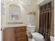 Bathroom with a granite vanity, toilet, and shower featuring a stylish curtain at 250 Maison Dr. # J-11, Myrtle Beach, SC 29572