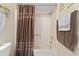 Cozy bathroom featuring a shower-tub combo, brown shower curtain, and neutral wall color at 250 Maison Dr. # J-11, Myrtle Beach, SC 29572