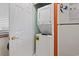 Stackable washer and dryer unit next to a door, within a bright laundry area at 250 Maison Dr. # J-11, Myrtle Beach, SC 29572