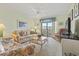 Cozy living room with floral sofas, fan, and a sliding glass door at 250 Maison Dr. # J-11, Myrtle Beach, SC 29572