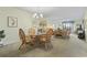 Open-concept living room featuring wicker furniture, chandelier, and neutral walls at 250 Maison Dr. # J-11, Myrtle Beach, SC 29572