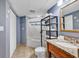Cozy bathroom featuring a tub with shower, granite vanity, and shelving unit for extra storage at 2504 N Ocean Blvd. # 934, Myrtle Beach, SC 29577