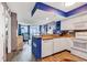 Open concept kitchen with modern white appliances, blue accents, and a view of the dining and living area at 2504 N Ocean Blvd. # 934, Myrtle Beach, SC 29577