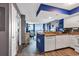Bright, open kitchen featuring white appliances, blue accents, and seamless flow into the living and dining space at 2504 N Ocean Blvd. # 934, Myrtle Beach, SC 29577
