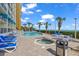Outdoor pool and hot tub, surrounded by lounge chairs, tables and chairs, with ocean views at 2504 N Ocean Blvd. # 934, Myrtle Beach, SC 29577