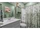 Bathroom with a shower-tub combination and a green painted vanity with white countertops and plenty of storage at 291 Brackish Dr. # 291, Myrtle Beach, SC 29588