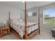 Bedroom featuring a four poster bed with a neutral color scheme, two windows, and grey carpet at 291 Brackish Dr. # 291, Myrtle Beach, SC 29588