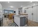 Open kitchen boasts granite countertops, a large island, and a modern sliding barn door at 291 Brackish Dr. # 291, Myrtle Beach, SC 29588