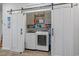 Laundry room with two large sliding doors, washer, dryer, and cabinets for storage at 291 Brackish Dr. # 291, Myrtle Beach, SC 29588