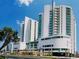 Modern condominium complex with multiple floors and palm trees at 300 N Ocean Blvd. # 1732, North Myrtle Beach, SC 29582