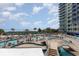 Beautiful pool area with seating, umbrellas, and a partial view of the beach and ocean at 300 N Ocean Blvd. # 1732, North Myrtle Beach, SC 29582