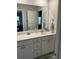Bathroom with a large mirror above the white vanity at 3019 Visionary Dr., Myrtle Beach, SC 29588