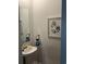 Charming powder room with pedestal sink, decorative mirror, and stylish oyster art at 3019 Visionary Dr., Myrtle Beach, SC 29588