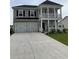 Charming two-story home featuring a spacious front yard, two-car garage, and a double porch at 3019 Visionary Dr., Myrtle Beach, SC 29588