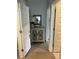 Hallway with an accent cabinet and lamp, showcasing a well-lit and inviting transition space at 3019 Visionary Dr., Myrtle Beach, SC 29588