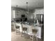 Bright kitchen features stainless steel appliances, pendant lighting, and a spacious granite countertop island at 3019 Visionary Dr., Myrtle Beach, SC 29588