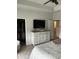 Comfortable main bedroom highlighting stylish dresser, TV, walk-in closet, and ensuite bathroom at 3019 Visionary Dr., Myrtle Beach, SC 29588