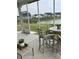 View of the screened porch from the backyard showing the outdoor dining and serene lake view at 3019 Visionary Dr., Myrtle Beach, SC 29588