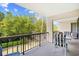 Outdoor balcony area overlooking green grass with chairs and table at 311 71St Ave. N # 3-D, Myrtle Beach, SC 29572
