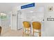 Bright white kitchen features a breakfast bar with wicker chairs, with modern appliances and decor at 311 71St Ave. N # 3-D, Myrtle Beach, SC 29572