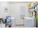 Well-lit laundry room with two sets of washer and dryers and storage shelves at 311 71St Ave. N # 3-D, Myrtle Beach, SC 29572