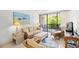 Comfortable living room with wicker furnishings, beach-themed art, and sliding glass doors to an outdoor balcony at 311 71St Ave. N # 3-D, Myrtle Beach, SC 29572