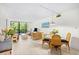 Bright living and dining area with wicker furniture, light wood floors and sliding glass doors to a balcony at 311 71St Ave. N # 3-D, Myrtle Beach, SC 29572