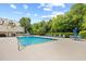 Enjoy the community pool surrounded by lounge chairs and lush landscaping on a sunny day at 311 71St Ave. N # 3-D, Myrtle Beach, SC 29572