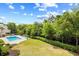 Resort-style pool surrounded by lush greenery and lounge chairs at 311 71St Ave. N # 3-D, Myrtle Beach, SC 29572