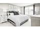 Serene bedroom with a queen size bed, grey walls, and modern decor with bright, natural light at 3208 Nw Edgemead Circle # B, Calabash, NC 28467