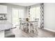 Bright dining area with a white table, six chairs, and sliding doors for outdoor access at 3208 Nw Edgemead Circle # B, Calabash, NC 28467