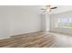 Bedroom featuring hardwood floors, ceiling fan, natural light from the window, and neutral color palette at 3332 Little Bay Dr., Conway, SC 29526