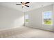 Spacious bedroom with plush carpet, natural light, and a tray ceiling with ceiling fan at 3332 Little Bay Dr., Conway, SC 29526