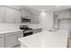 Modern kitchen featuring gray cabinetry, stainless steel appliances, and a large island with quartz countertops at 3332 Little Bay Dr., Conway, SC 29526