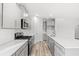Bright kitchen with stainless steel appliances, gray cabinets, quartz countertops and wood flooring at 3332 Little Bay Dr., Conway, SC 29526
