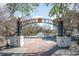 Ornate 'River Walk' sign over a brick path, framed by trees and street lamps under a partly cloudy sky at 3332 Little Bay Dr., Conway, SC 29526