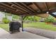 Covered outdoor patio area, complete with a grill and a view of the grassy backyard at 4 Catawba Ct., Myrtle Beach, SC 29588