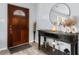 Inviting entryway with a decorative door, stylish console table, and a round mirror that enhances the bright space at 4 Catawba Ct., Myrtle Beach, SC 29588