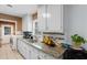 Well-lit kitchen boasting granite counters, mosaic backsplash and modern appliances next to laundry area at 4 Catawba Ct., Myrtle Beach, SC 29588