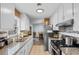 Efficient kitchen with granite countertops, white cabinetry, and a view to the dining area at 4 Catawba Ct., Myrtle Beach, SC 29588