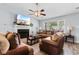 Cozy living room featuring a fireplace, large windows, and comfortable seating with a view of a mounted TV at 4 Catawba Ct., Myrtle Beach, SC 29588