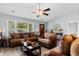 Comfortable living room featuring stylish sofas, natural light, wood floors and ceiling fan, perfect for relaxation at 4 Catawba Ct., Myrtle Beach, SC 29588