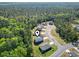 An aerial shot shows the property's location within a community surrounded by a lush, green forest at 4005 Sweetspire Court, Conway, SC 29526