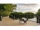 Scenic view of a wooden boardwalk with a bench overlooking the calm water and lush greenery at 4005 Sweetspire Court, Conway, SC 29526